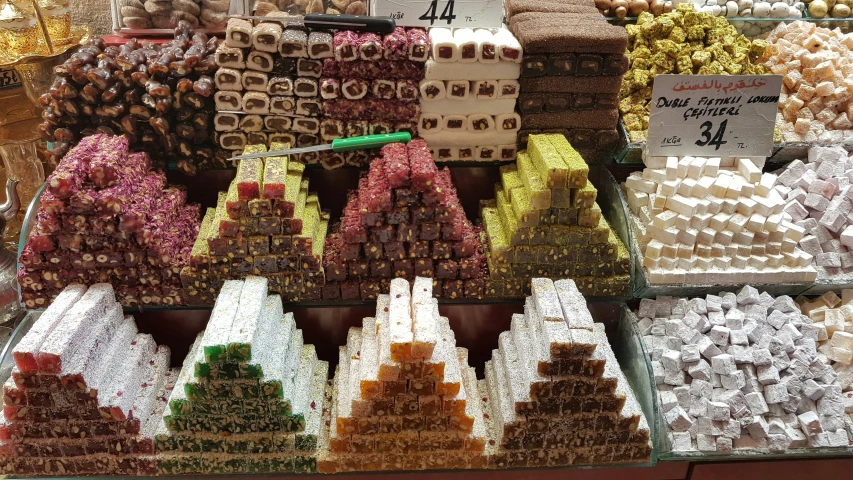 many different candies and cakes with a price tag