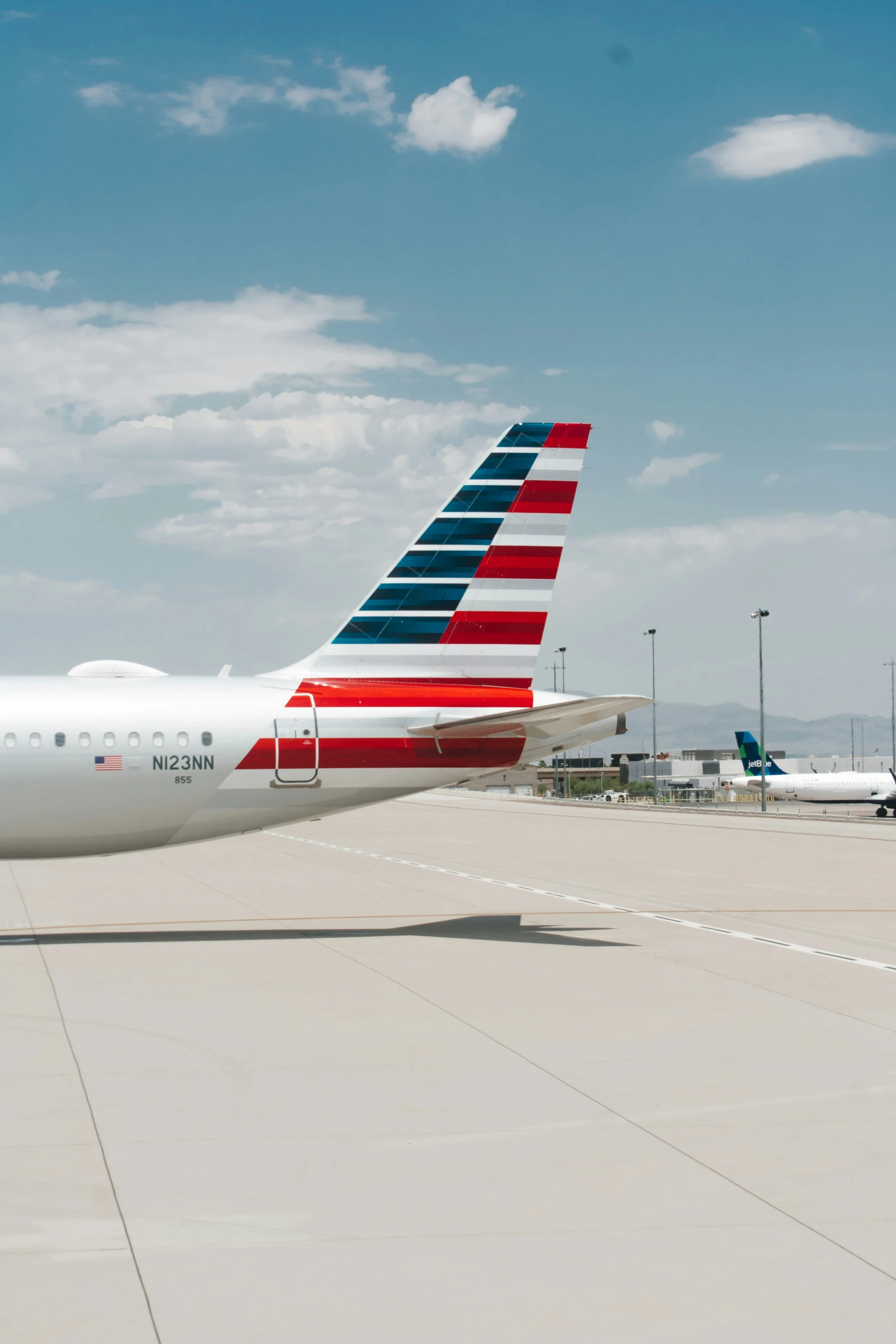 american airlines airplane on a tarmac and looking at the air traffic