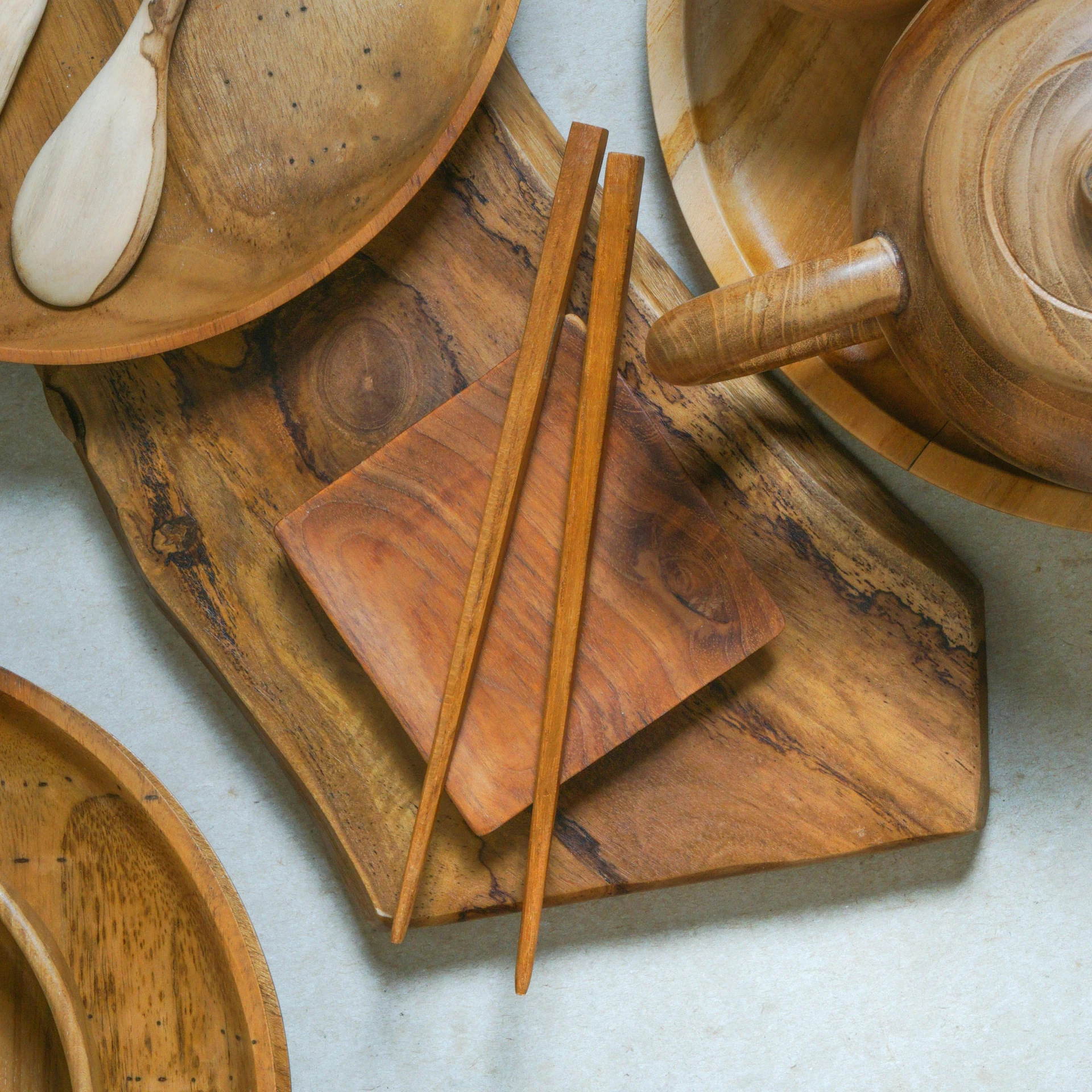 wooden spoons and chopsticks set up on top of plates