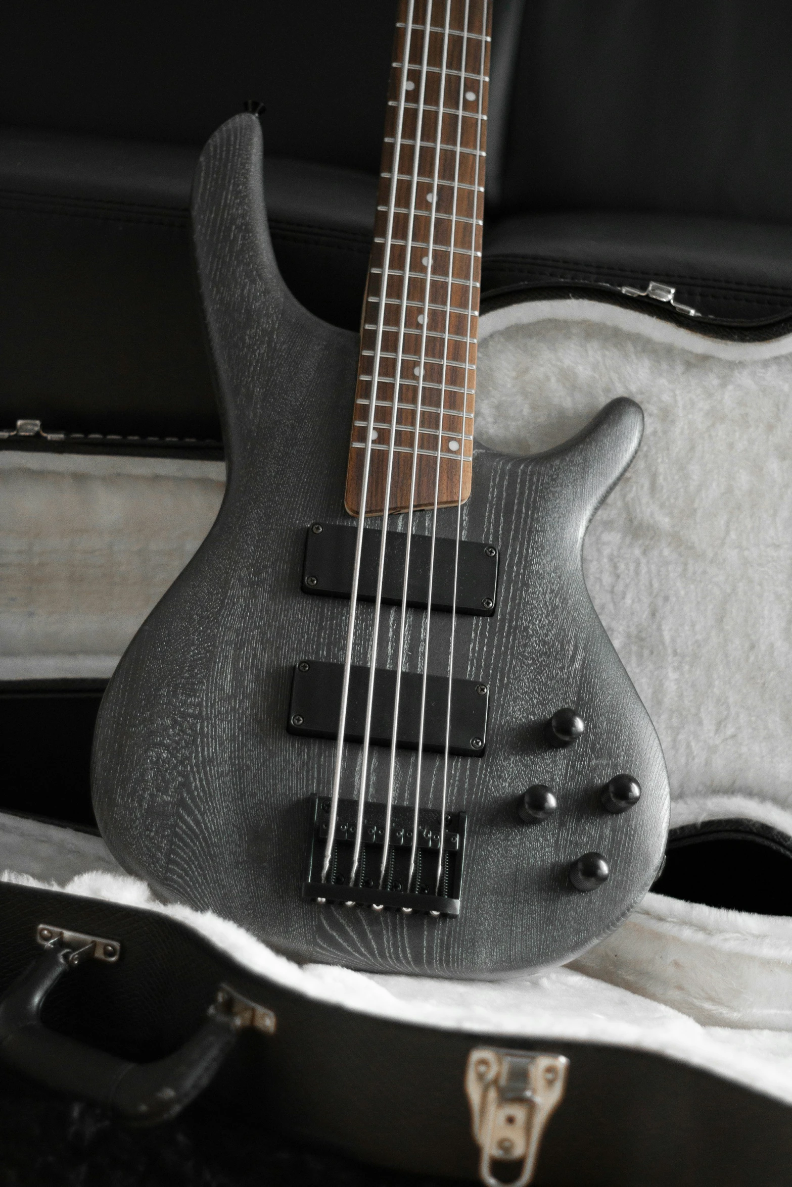 a bass guitar that is made from dark gray granite