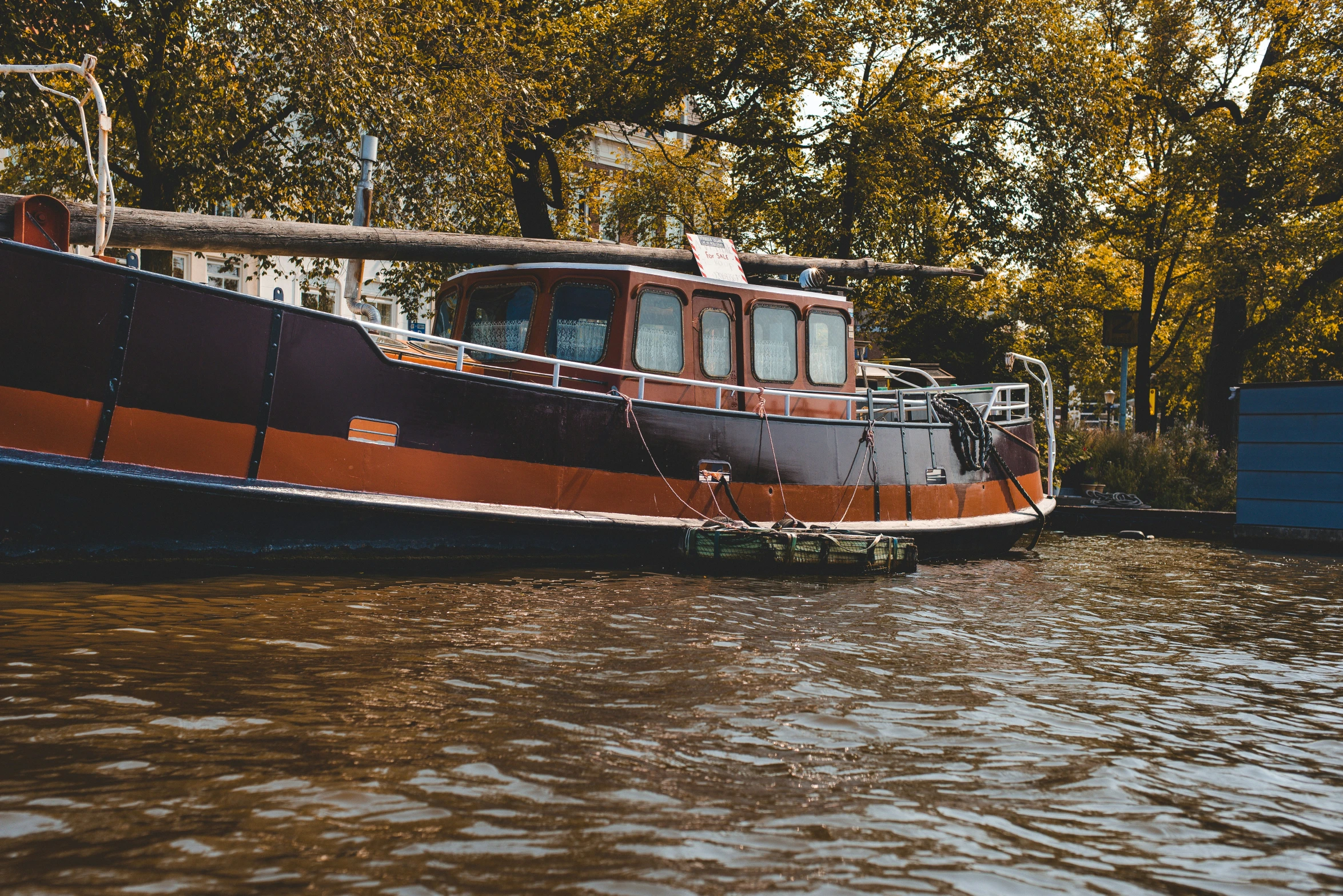 an old boat sits in the water outside