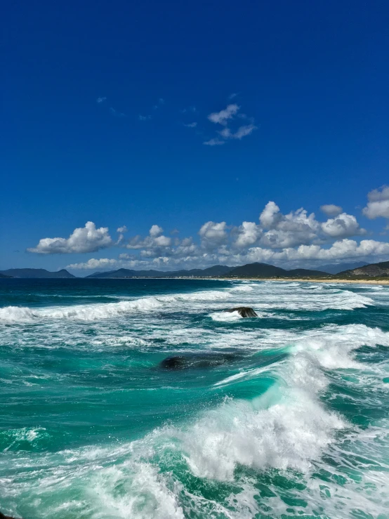 the blue and white ocean is full of waves