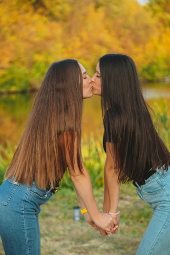 two beautiful women giving each other a kiss