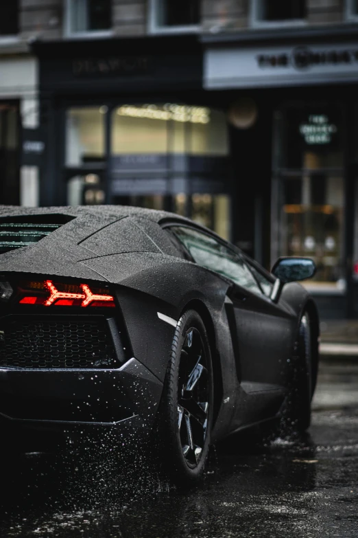 a very pretty black sports car on the street