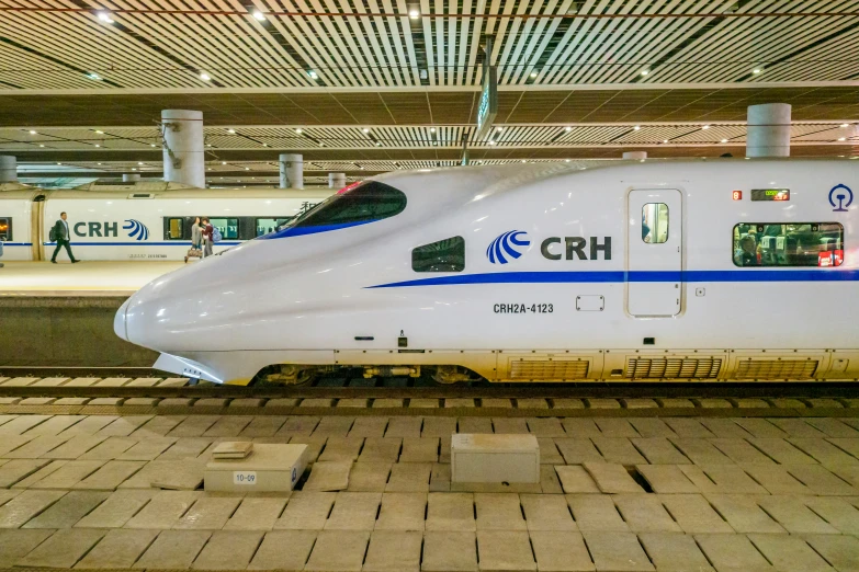 a white train in a large building at night