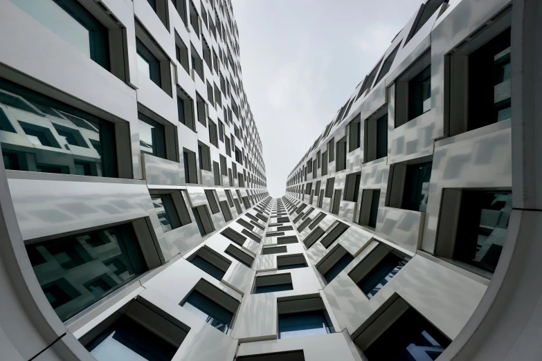 the building facades are reflecting the sky