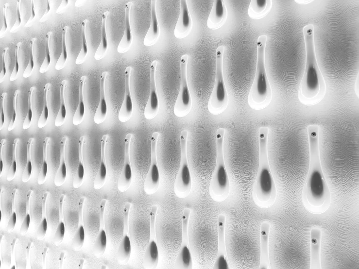 a wall with a lot of spoons and hooks