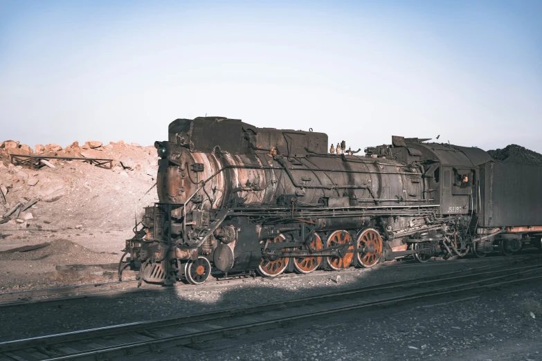 an old rusty train engine with rust on the train tracks