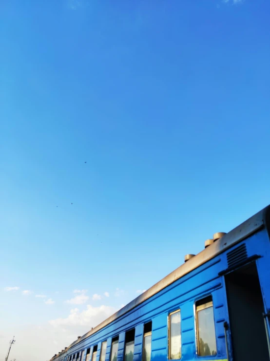 a passenger train passing by some people walking near