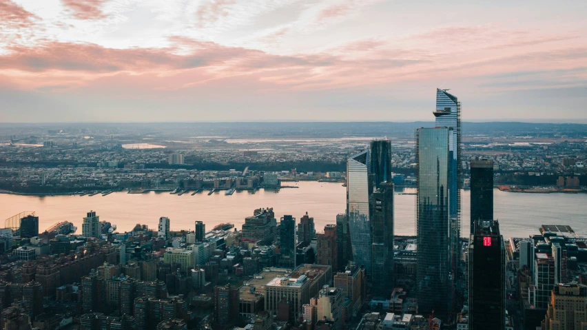 an aerial view of two buildings and a body of water