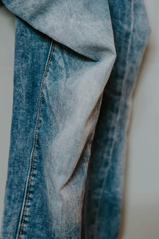 close up of a person wearing blue jeans