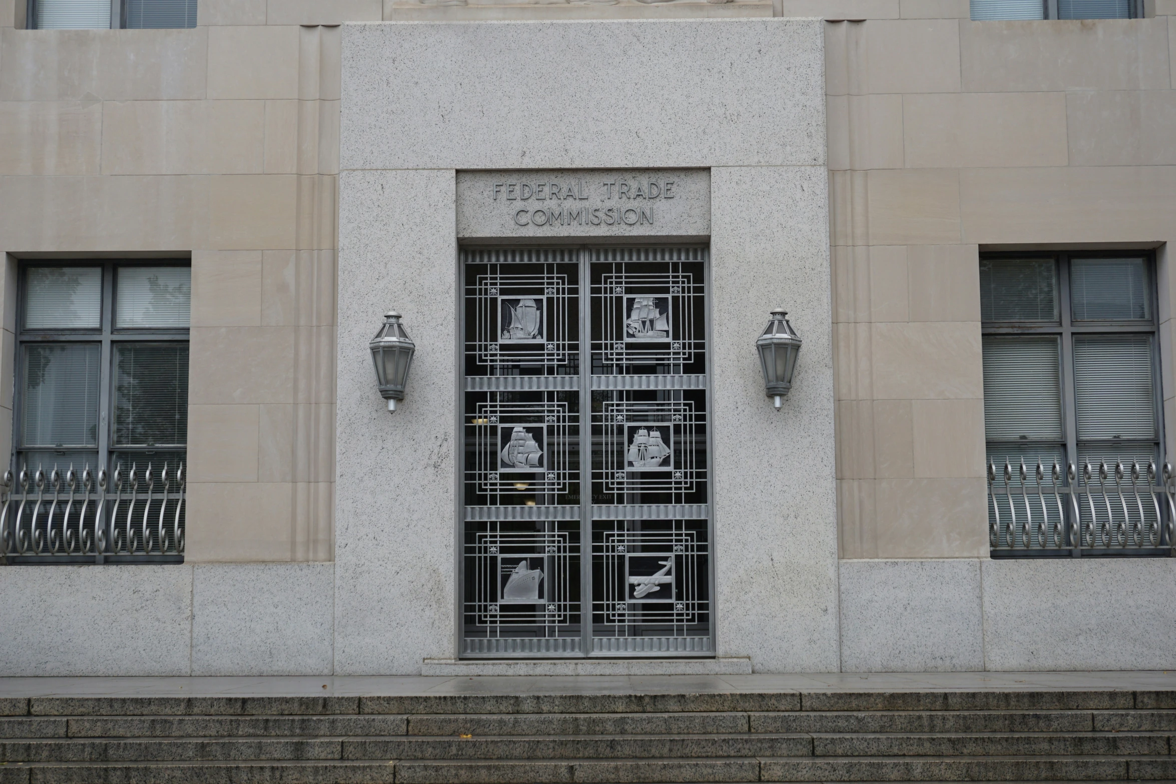 an old looking window with wrought iron designs on the front