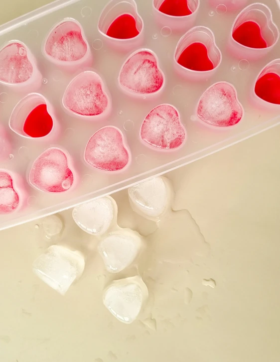 some ice hearts that are sitting in a plastic container