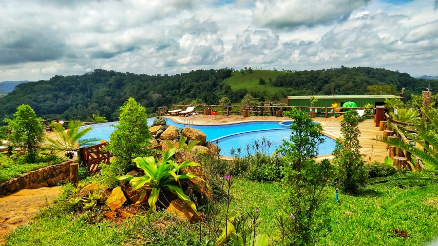 a very big pool with a bunch of trees in the background