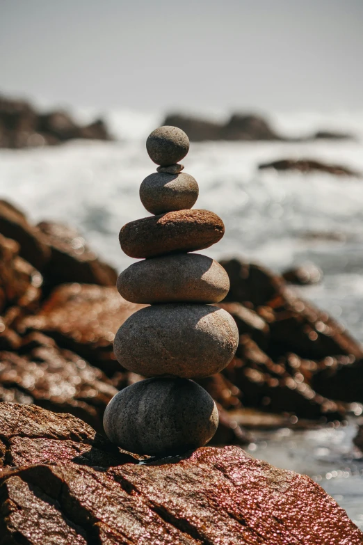 stacked rocks by the ocean and the shore