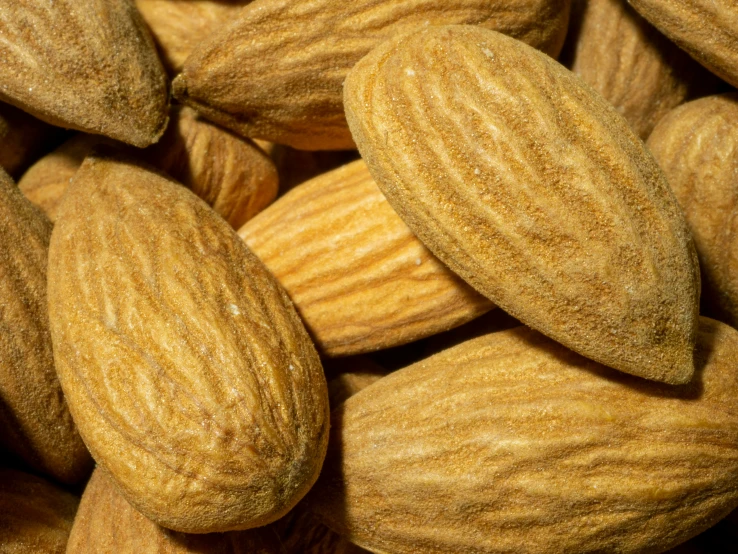 almonds are scattered on top of each other