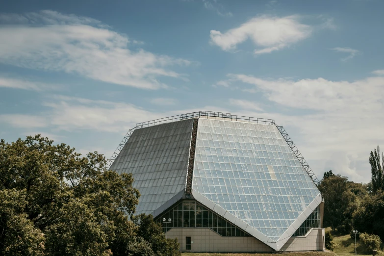 a large pyramid shaped building in a grassy field