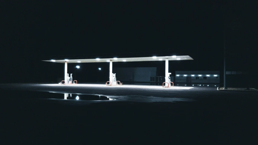 a gas station sitting at night in the dark
