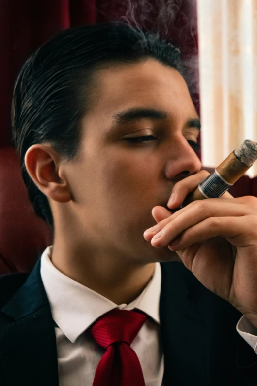 a man is smoking a cigarette in a suit