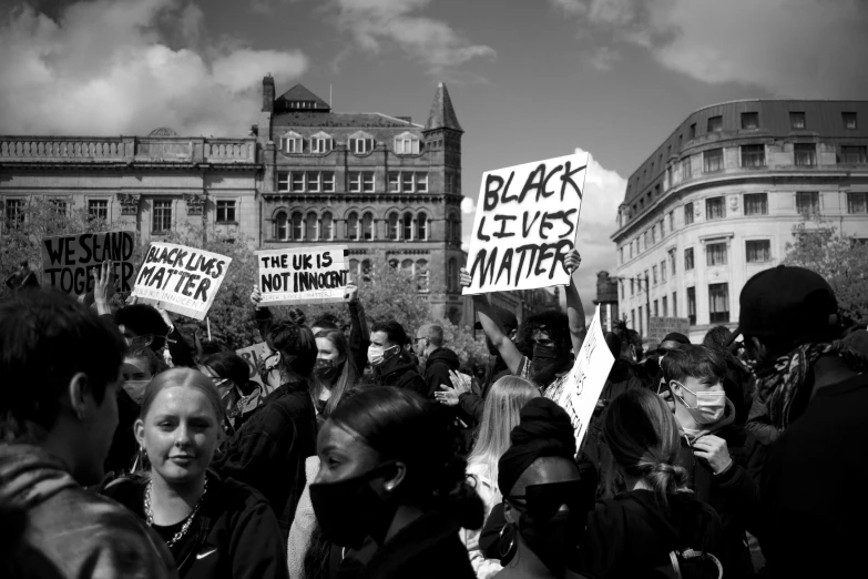 a bunch of people holding up signs and protesting