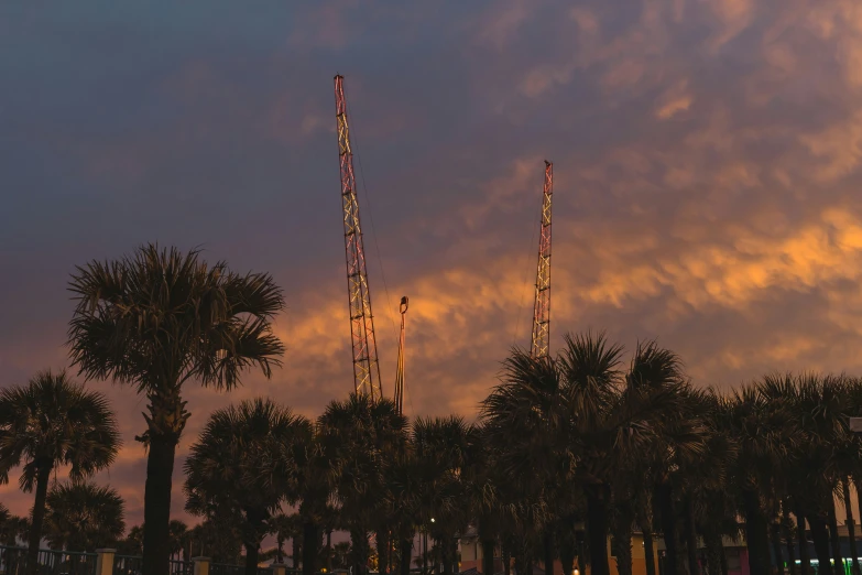 the sky is filled with pink clouds and some buildings