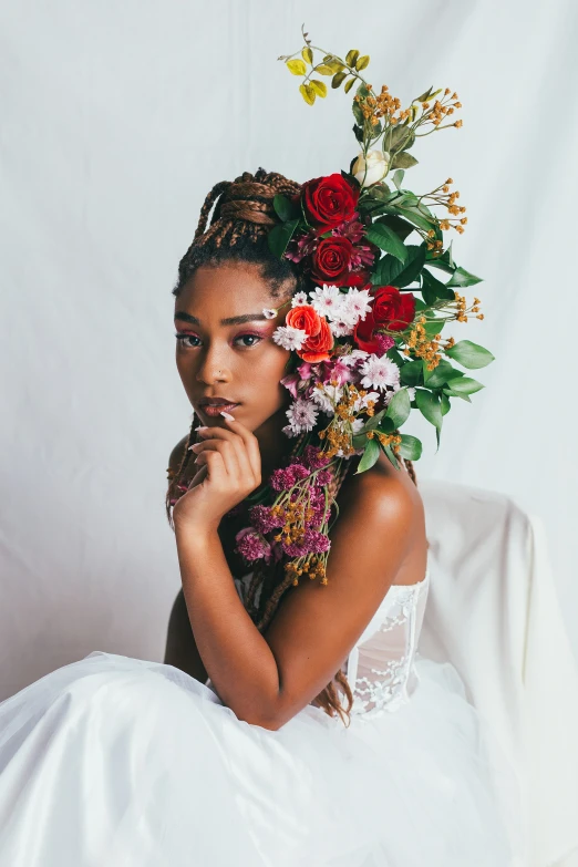 a beautiful woman posing with flowers on her head