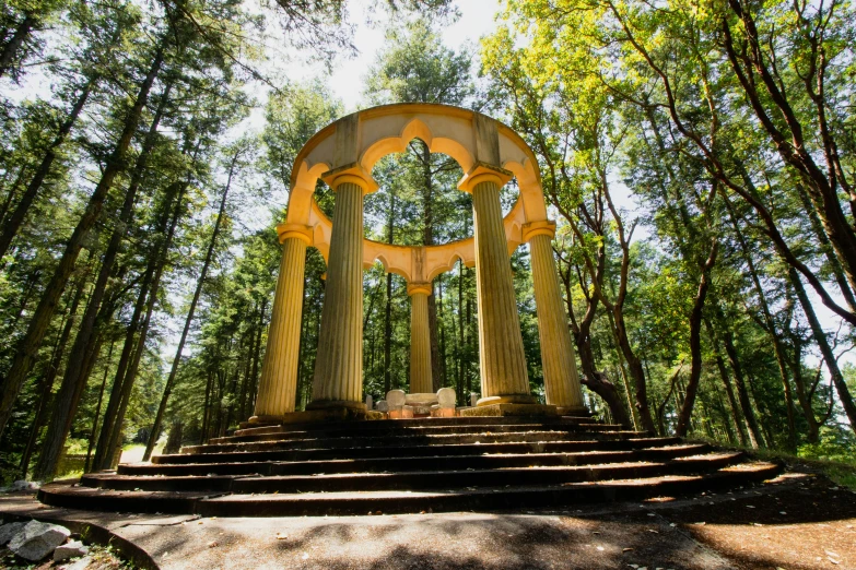 a large monument surrounded by trees on top of a stone steps