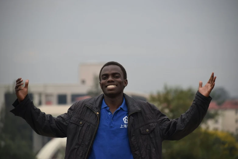 a man with both hands in the air