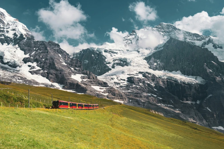 the train is running between some beautiful mountains