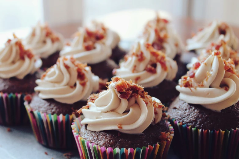 cupcakes with cream cheese frosting and chopped bacon on top