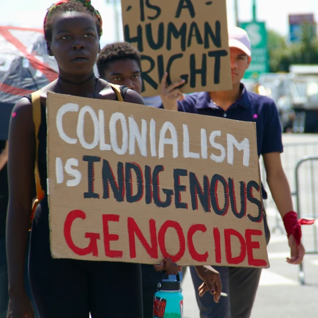 some people holding placards protesting in protest