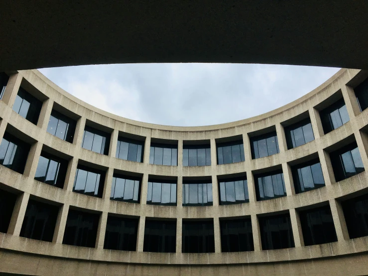 a circular building has glass windows on both sides