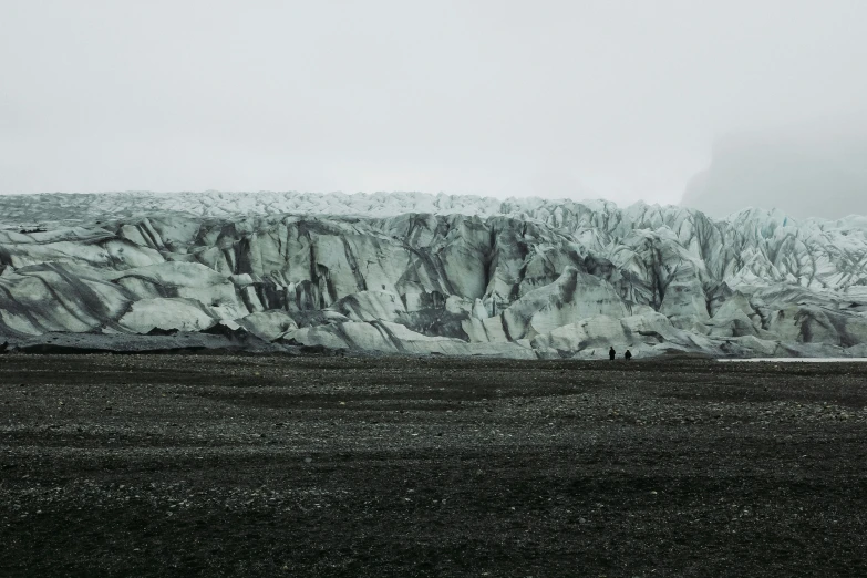 the people are standing on the mountain side