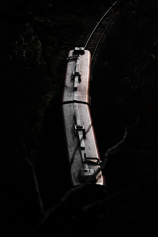 an elevated rail car in the dark, with its back light on