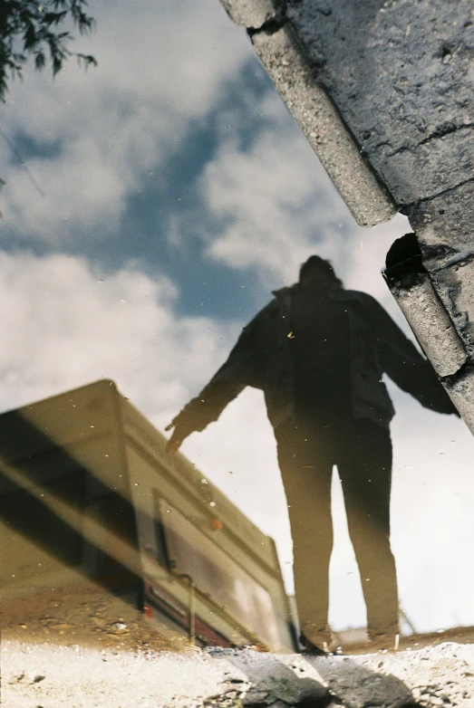 a silhouette of a man in front of a building