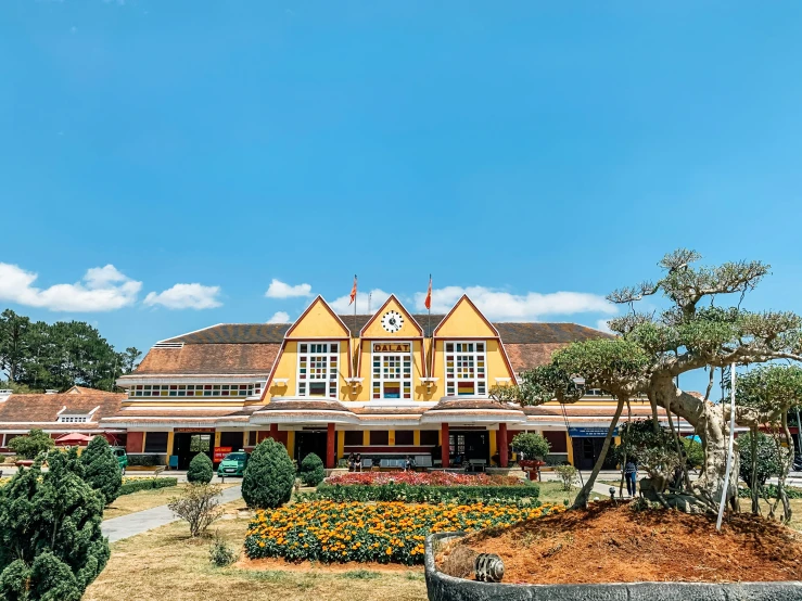 a large house with white windows and red roof on a nice day