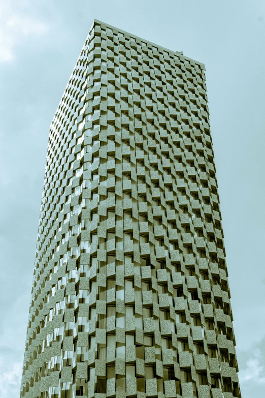 a very tall building with small cubes covering the entire side