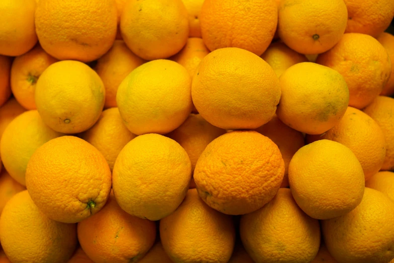 a pile of fresh yellow lemons ready to be sold