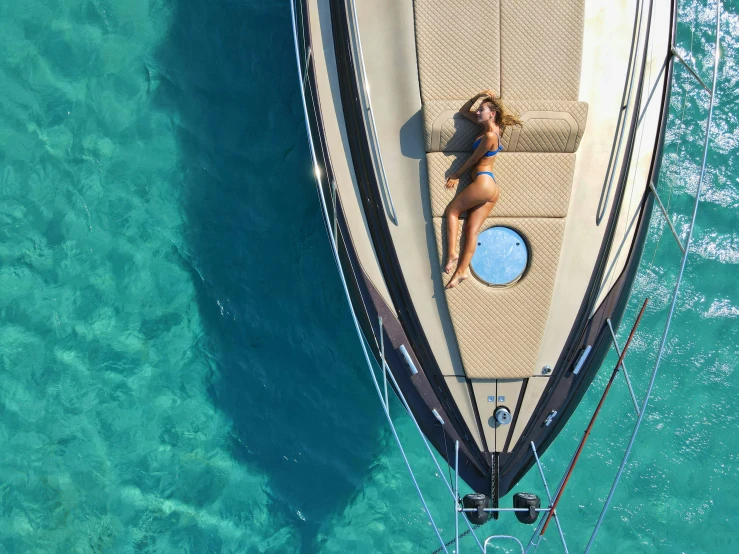 a woman sits on the front of a boat