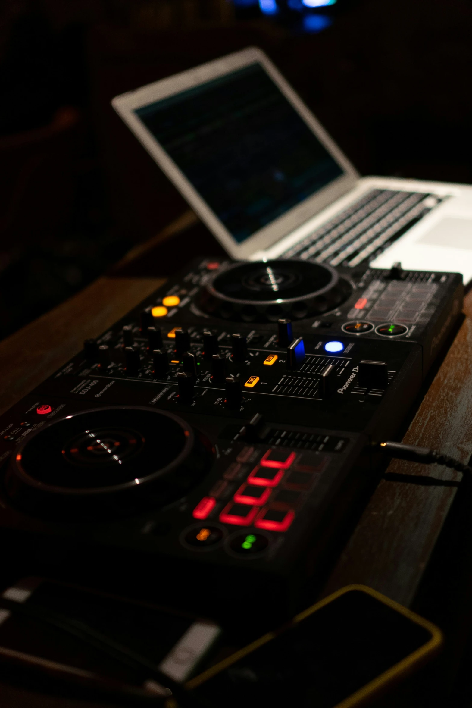 a laptop computer sitting on top of a table next to a sound board