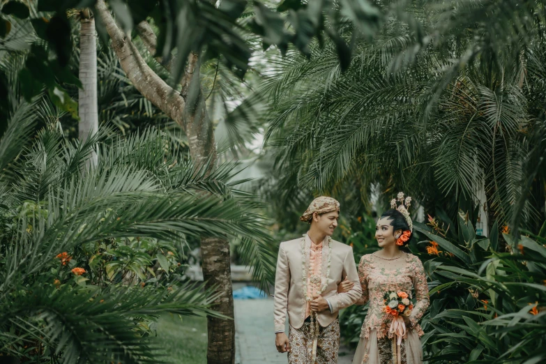 a couple stands next to each other in the jungle