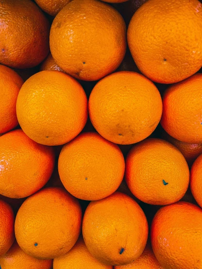 a group of oranges stacked together on top of each other