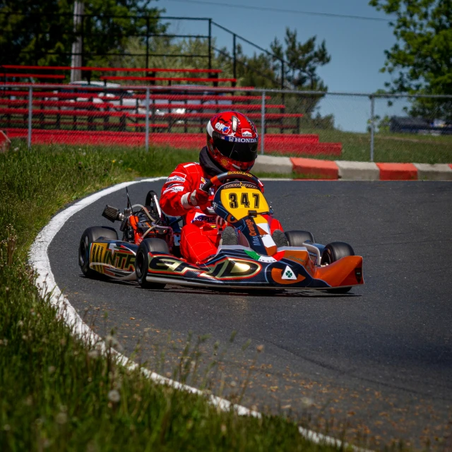 a person is racing on an orange and black motorcycle