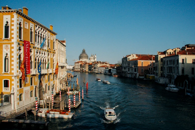 a boat passing down the river next to buildings