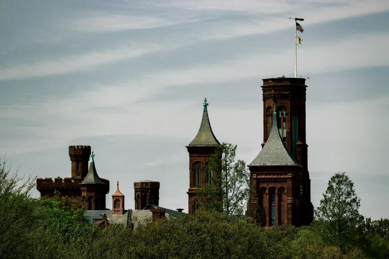 a large building with two towers and flags on top