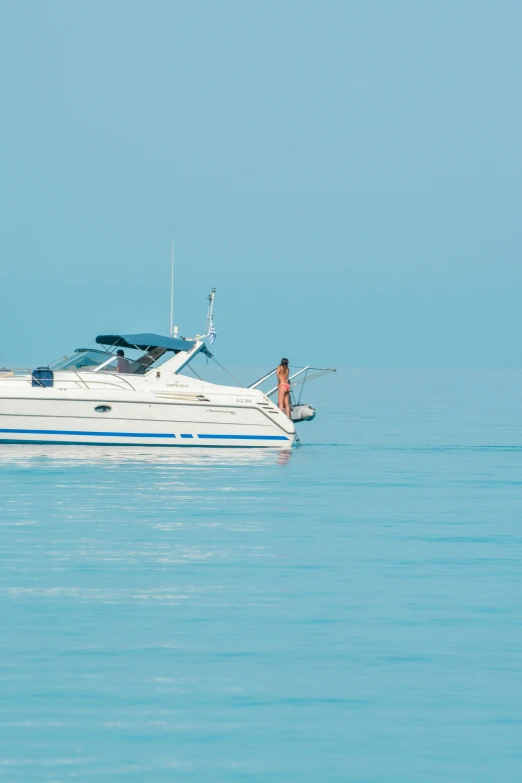 a person sits on top of a boat on the water