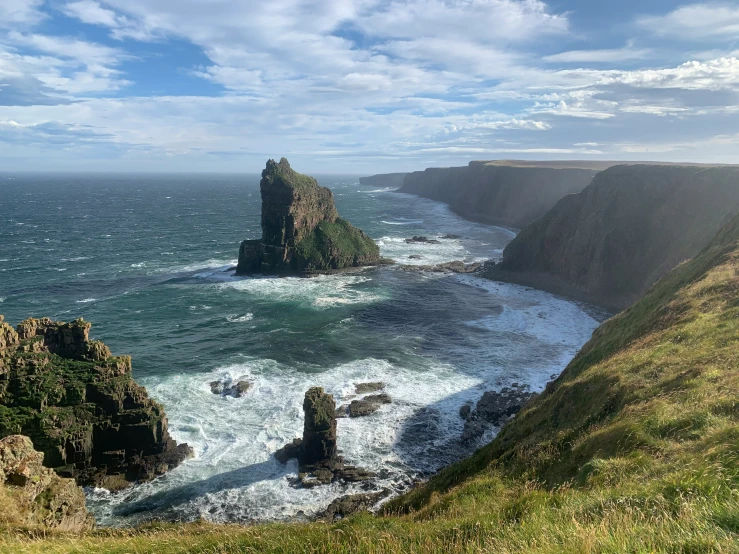 a rocky shore on the edge of an ocean