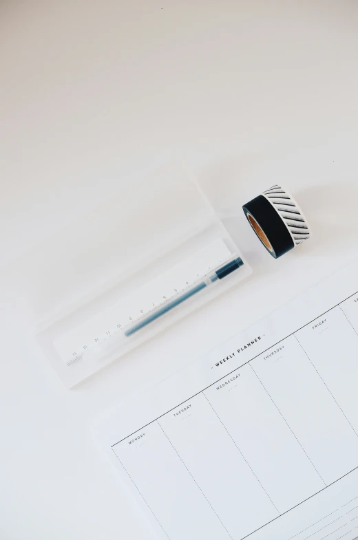 this is a picture of a desk with notepad and pen on it