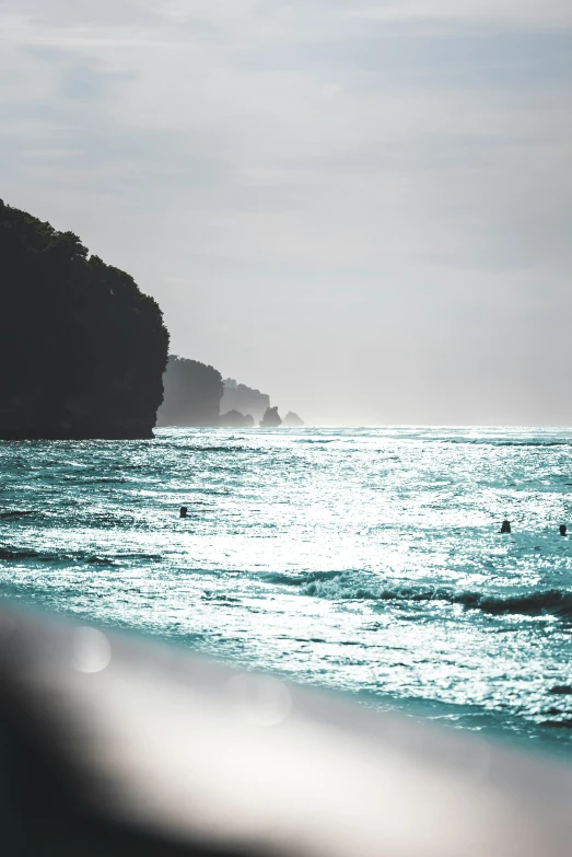 surfers ride on top of a wave and surf the ocean