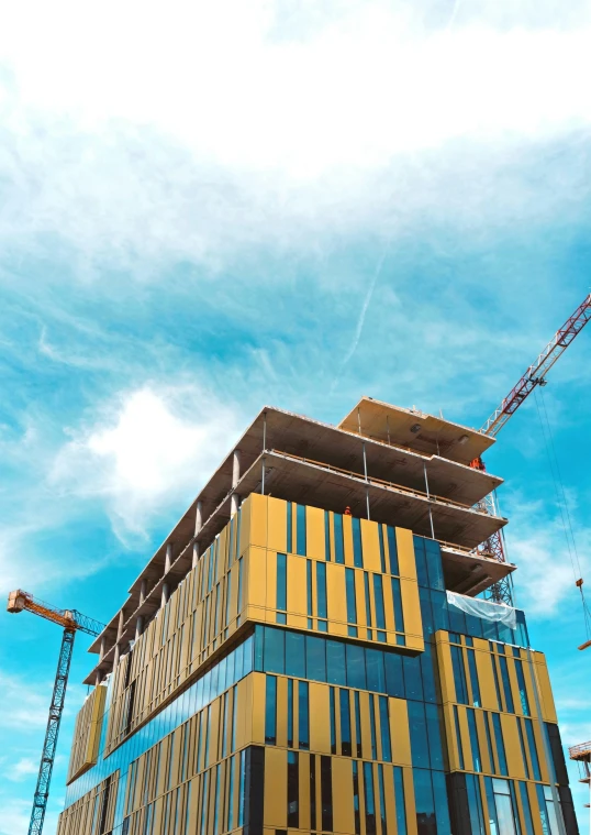 a tall building that is under construction next to a crane